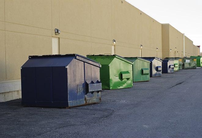 large construction waste containers in a row at a job site in Burlington